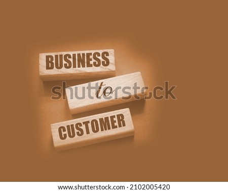 Business to Customer inscription made on wooden blocks on grey tabletop. B2C business marketing concept.