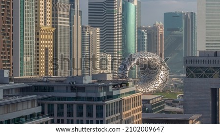 Dubai International Financial district aerial morning timelapse. Close up view of business and financial office towers. Skyscrapers with hotels and museum near downtown Royalty-Free Stock Photo #2102009647