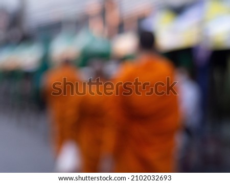 blurry images of monks walking alms