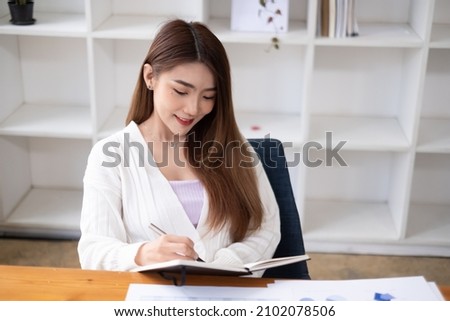 Beautiful businesswoman sitting at table opposite laptop in workplace brainstorming new project, People technology Concept