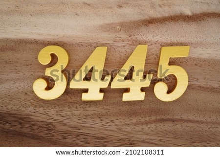 Golden Arabic numerals 3445 on a dark brown to white wood grain background.
