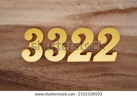 Golden Arabic numerals 3322 on a dark brown to white wood grain background.