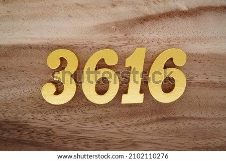 Golden Arabic numerals 3616 on a dark brown to white wood grain background.