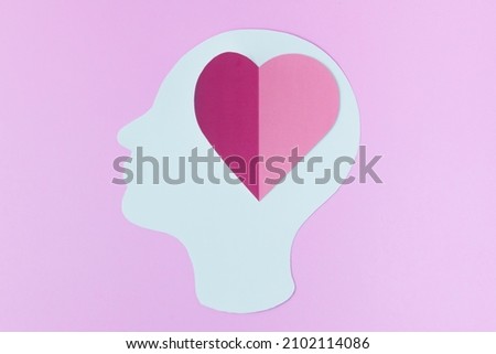 Human head and heart symbol on pink background. concept Fallen in love, Romantic feeling.