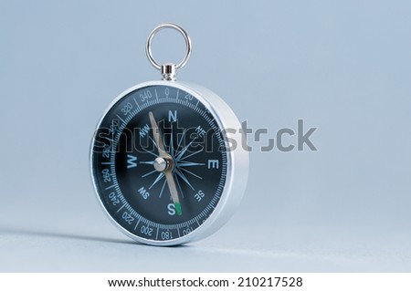 Compass on the grey background. Studio shot. Close-up. 