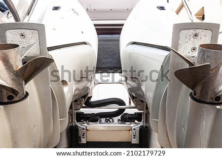 Motor propellers for motor yachts and boats close-up. The motors are installed at the stern of the boat. The outboard motors at the stern of the boat are raised. Royalty-Free Stock Photo #2102179729