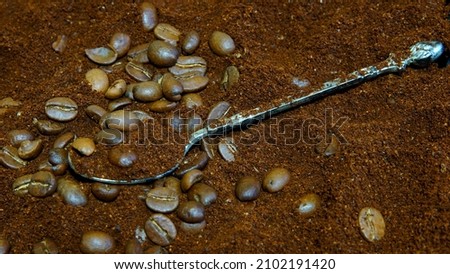 
Ground coffee, coffee beans silver vintage spoon background abstraction, selective focus					