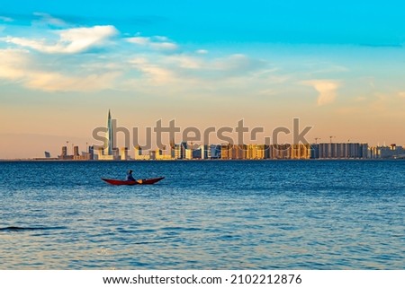 a man on a boat during sunset far from the shore. background picture. space for printing text.