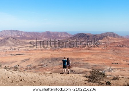 Tourists taking pictures of the dry landscape in Fuerteventura, Canary Islands, Spain
