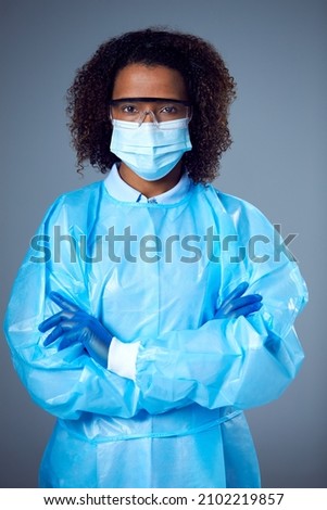 Studio Portrait Of Female Lab Worker in PPE With Face Mask And Safety Glasses