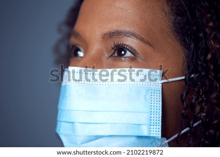 Close Up Studio Portrait Of Female Doctor in PPE With Face Mask