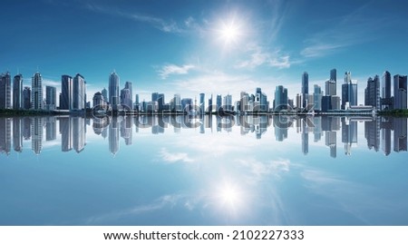 Blue tone panorama of waterfront city skyline with reflection. Image composite. Royalty-Free Stock Photo #2102227333