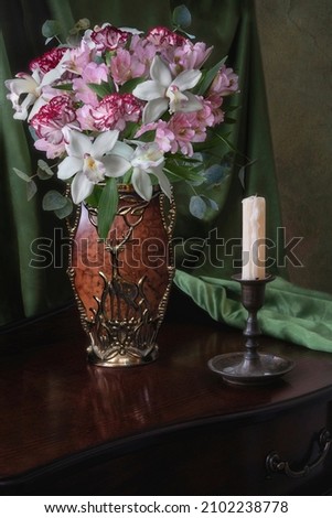 Still life with a luxurious bouquet and candlestick