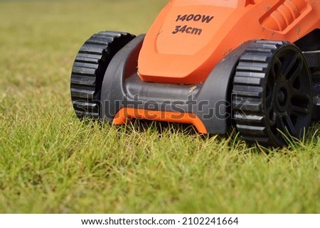 electric lawn mower placed on the lawn