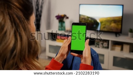 Woman Using Smartphone with Green Screen for Copy Space Close up Chroma Key Mockup. Scrolling Gestures. Girl watcing gadget green screen and touch display.