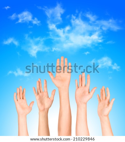 many open hands raised up against the sky,business concept