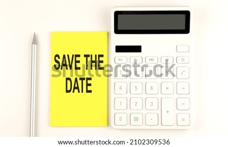 text SAVE THE DATE on the yellow sticker, next to pen and calculator