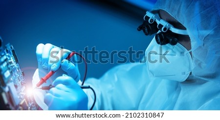 The scientist works in a modern scientific laboratory for the research and development of microelectronics and processors. Microprocessor manufacturing worker uses computer technology and equipment. Royalty-Free Stock Photo #2102310847