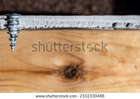 Technical depiction of how a drywall anchor is installed from a cutout side view. Royalty-Free Stock Photo #2102330488