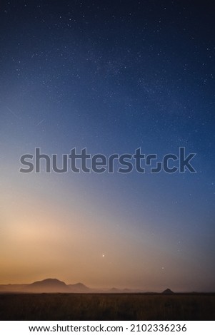 Beautiful vertical shot of a starry night sky over the sea-perfect for wallpapers