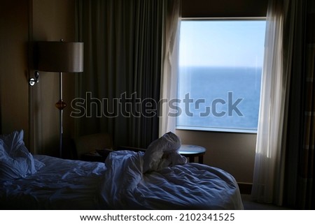 Unmade bed inside a hotel room Royalty-Free Stock Photo #2102341525