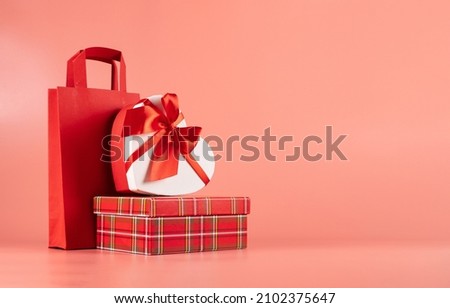Bright packaging for purchases, gifts and parcels on a pink background. The concept of delivery of gifts and parcels for the holidays valentines day, pleasant surprises. Shopping, sale, promotion