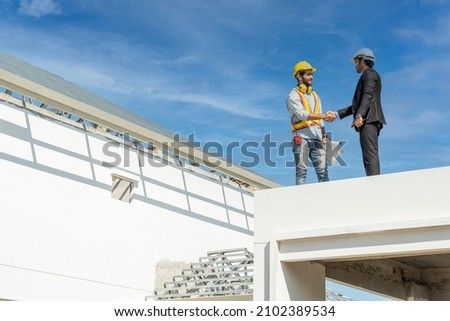 Project Manager and handshake congratulations
to Foreman, congratulations
on the completion of the goals of land development and house construction. Royalty-Free Stock Photo #2102389534