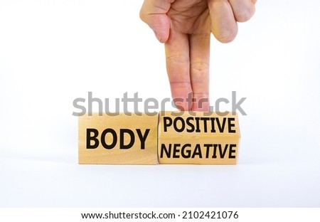 Body positive or negative symbol. Psychologist turns cubes, changes words body negative to body positive. Beautiful white background, copy space. Psychological, body positive or negative concept.