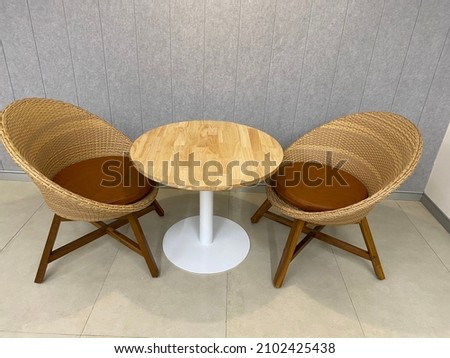 Wooden coffee tables in the restaurant with grey interior