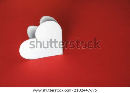 White blank heart made of paper on a red background. Valentine's Day