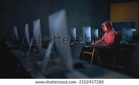 Concentrated Male Student Sitting Alone in College Informatics Room, Working Late Evenings on Computer Science Project. Young Scholar Study IT on Computer in University, Writing Code in Class. Royalty-Free Stock Photo #2102457280
