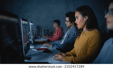 African American Female Student, Studying in Modern University with Diverse Multiethnic Classmates. College Scholars Work in College Room. Applying Her Knowledge to Acquire Academic Skills in Class. Royalty-Free Stock Photo #2102457289
