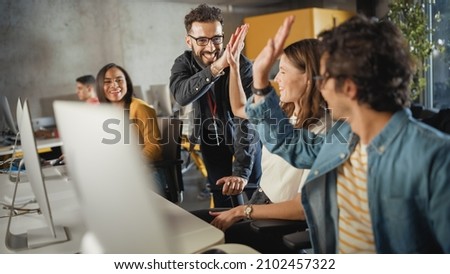 Lecturer Helps Scholar with Project, Advising on Their Work. Teacher Giving High Five to Diverse Multiethnic Group of Female and Male Students in College Room, Teaching Software Engineering. Royalty-Free Stock Photo #2102457322