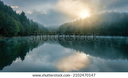 Beautiful scenic view of Savsat Karagol Black lake in Eastern Black Sea region with morning evaporation. Savsat Karagol lake is a large trout lake in the forest in Artvin, Turkey Royalty-Free Stock Photo #2102470147
