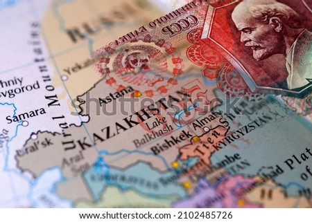 A map showing Kazakhstan in combination with a Russian ruble banknote Royalty-Free Stock Photo #2102485726