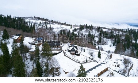 Winter vacation holiday wooden house in the mountains covered with snow and blue sky.