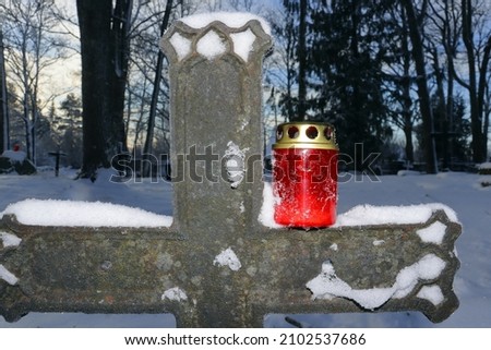 grave candle in the small winter cemetery