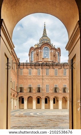 Turin, Italy, View of the courtyard of the Royal Palace of Savoy and the Chapel of the Holy Shroud through the arch. Royalty-Free Stock Photo #2102538676