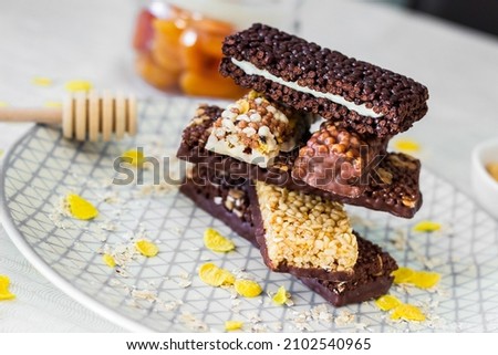 Granola energy bar with mix of nuts and fruits on a plate