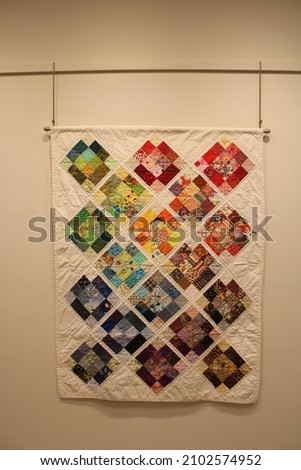 Handmade quilt with beautiful colors and designs. It took years of sewing and experiments with shapes and patterns and a lot of hard work. Quilt created by Carolyn Liebler.