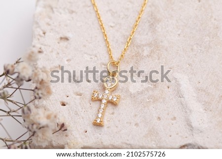 Silver cross necklace on beautiful background. Cross necklace image for e commerce, social media. Royalty-Free Stock Photo #2102575726