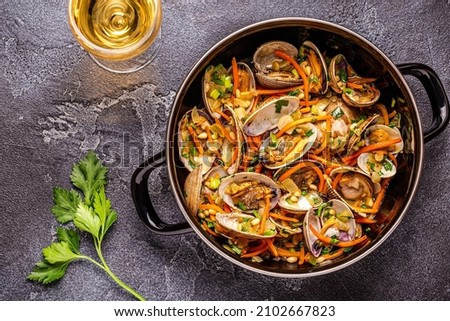 Shells vongole venus clams with vegetables and herbs.