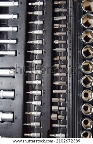 A set of professional wrenches in cradles, socket heads, ratchet wrench, torx. A set of ratchets with heads, different socket wrenches close-up in a brown plastic case. Car repair concept, auto deal.