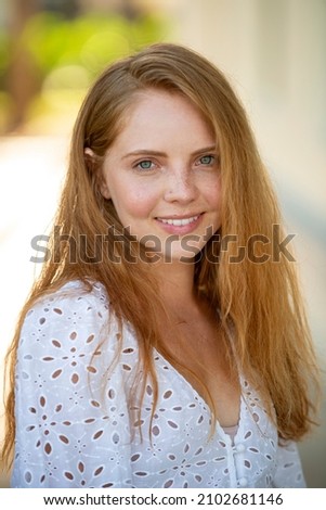 Woman with romantic smile. Close up face of young stylish woman. Beautiful fashionable girl outdoor portrait. Royalty-Free Stock Photo #2102681146