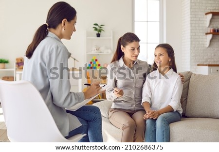 Talking is key to understanding. Parent and child seeing psychologist together. Counseling therapist and mother listening to preteen daughter sharing school news, telling story and answering questions Royalty-Free Stock Photo #2102686375