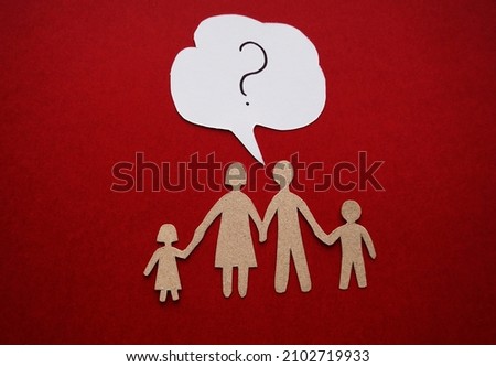 A family made of paper lies on a red background, dialogue