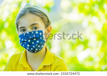 Little girl with mask against corona virus covid outdoor
