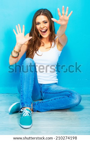 positive emotional portrait of young happy woman sitting on a floor