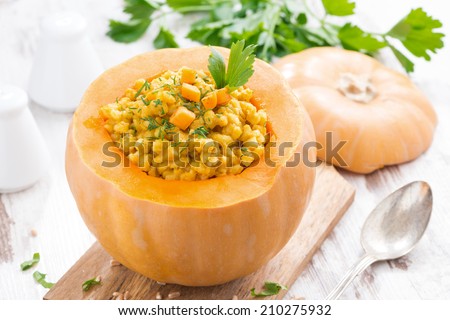 barley porridge baked in a pumpkin, close-up