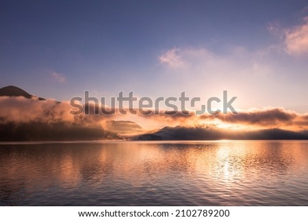 sunrise over kochelsee bavaria reflecting water